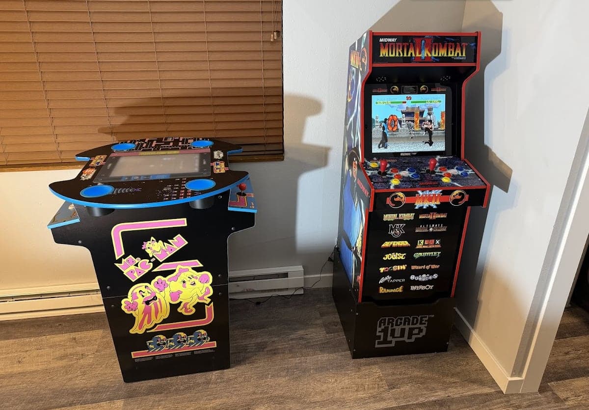 Home arcade with a Ms. Pac-Man cabinet and a Mortal Kombat II Arcade1Up machine