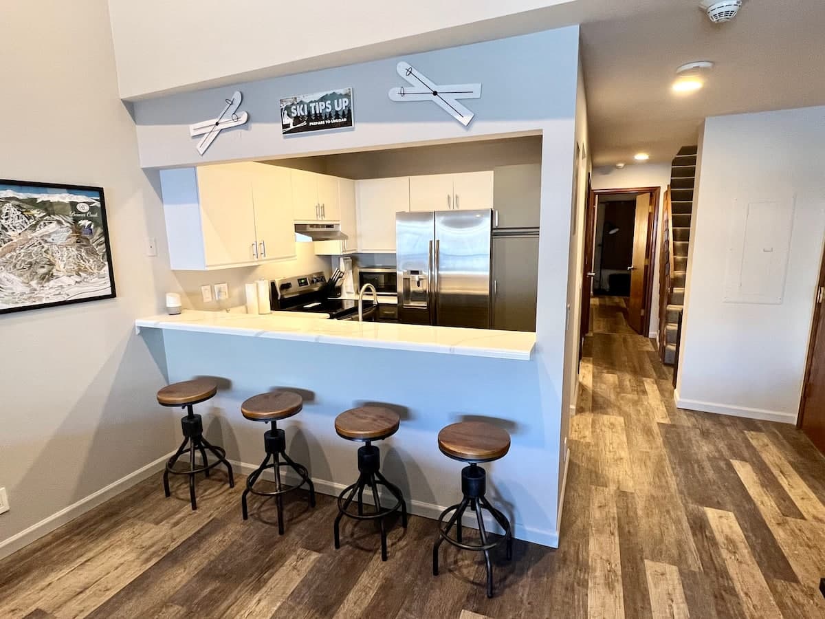 Updated kitchen with stainless appliances and bar seating for four